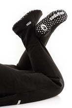 Load image into Gallery viewer, Man wearing lounges loungewear in black with feet up